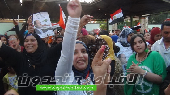 Egyptian women celebrate elections by dancing in front of ballot stations