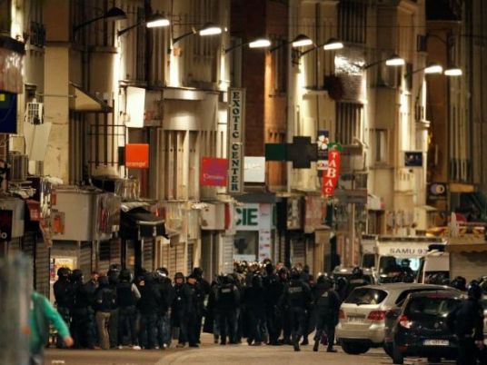 Suspect arrested over Paris attacks as raids continue across France