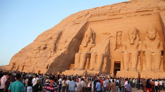 Tourists celebrate solar illumination of King Ramses II in Egypt’s Aswan