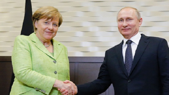 Putin, Merkel spar in Russia over election meddling