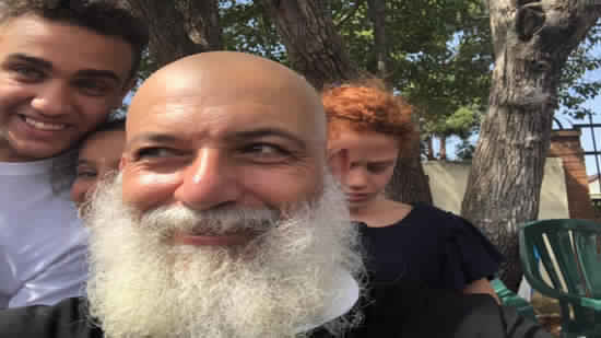 A Coptic priest in Australia shakes his hair in solidarity with cancer patients