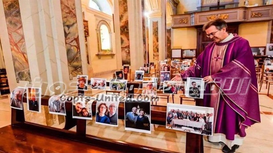 A priest accompanies pictures of the congregation in the church 