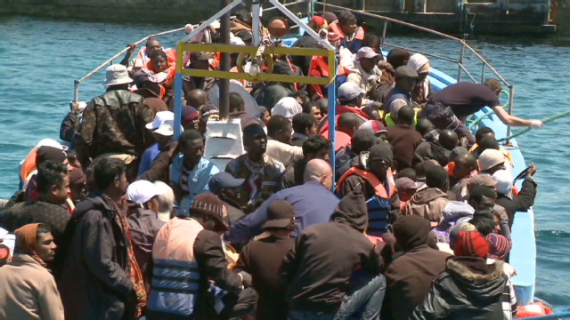 Boat crammed with refugees from Libya reaches tiny Italian island
