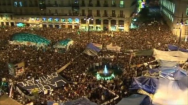 Spain protesters defy ban to remain in Madrid square
