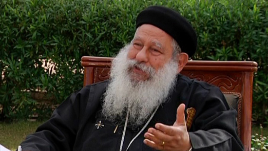 Father Makari Younan is interrogated after being charged with contempt of Islam