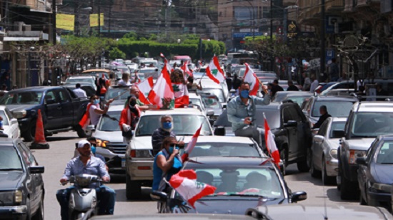 Lebanese protesters return to streets in car convoys amid coronavirus lockdown